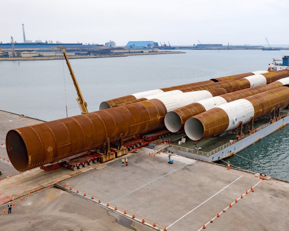 Mammoet handling offshore wind monopiles at the quay.jpg